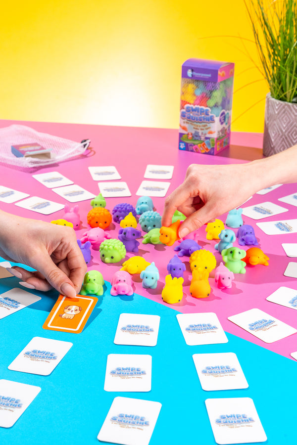 Swipe the Squishie game setup with vibrant squishy pieces and action playing cards designed for 2+ players aged 4 and up