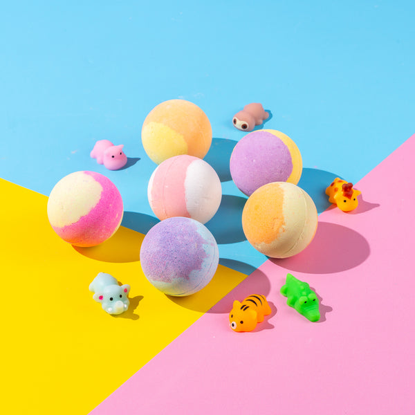 Six-pack of colourful fruity-scented bath bombs with hidden squishy sensory toys, designed for kids aged 3 and up